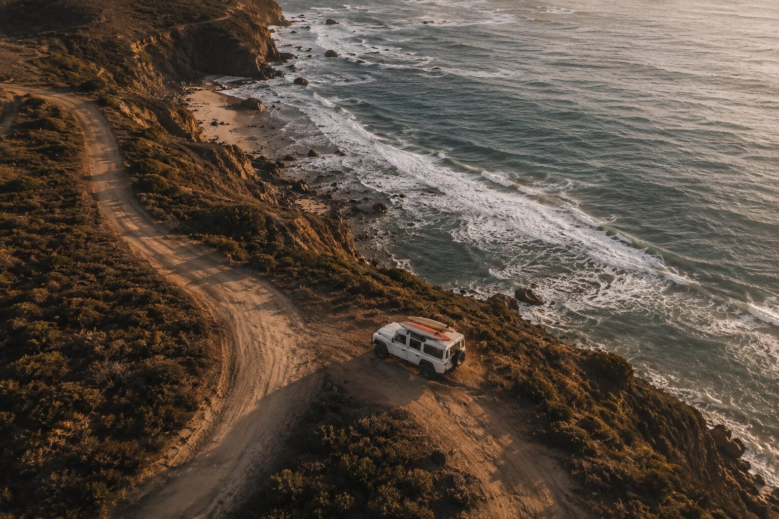 Aerial view of a coastal dirt road and 4WD